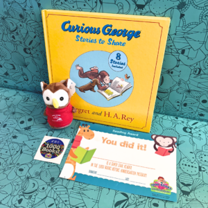 The image shows a yellow Curious George book titled, 'Curious George: Stories to Share,' a brown owl with a white face and a red shirt, and a certificate and sticker given when a child reads 1000 books