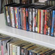 A row of DVDs is arranged neatly on a shelf.